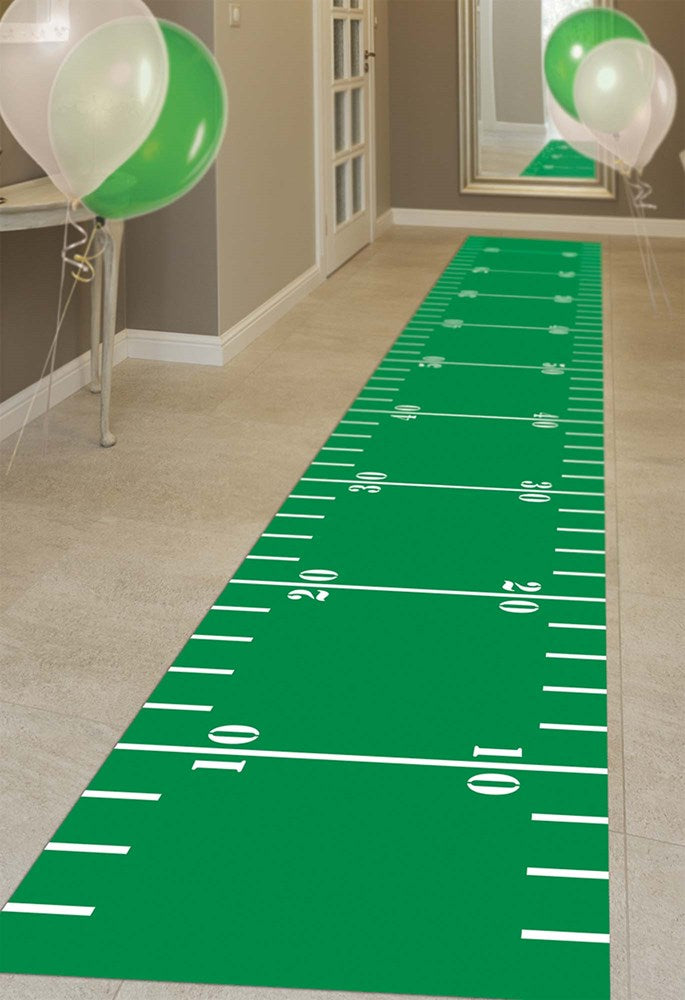 Green floor runner designed like a football field with white yard lines and numbers.