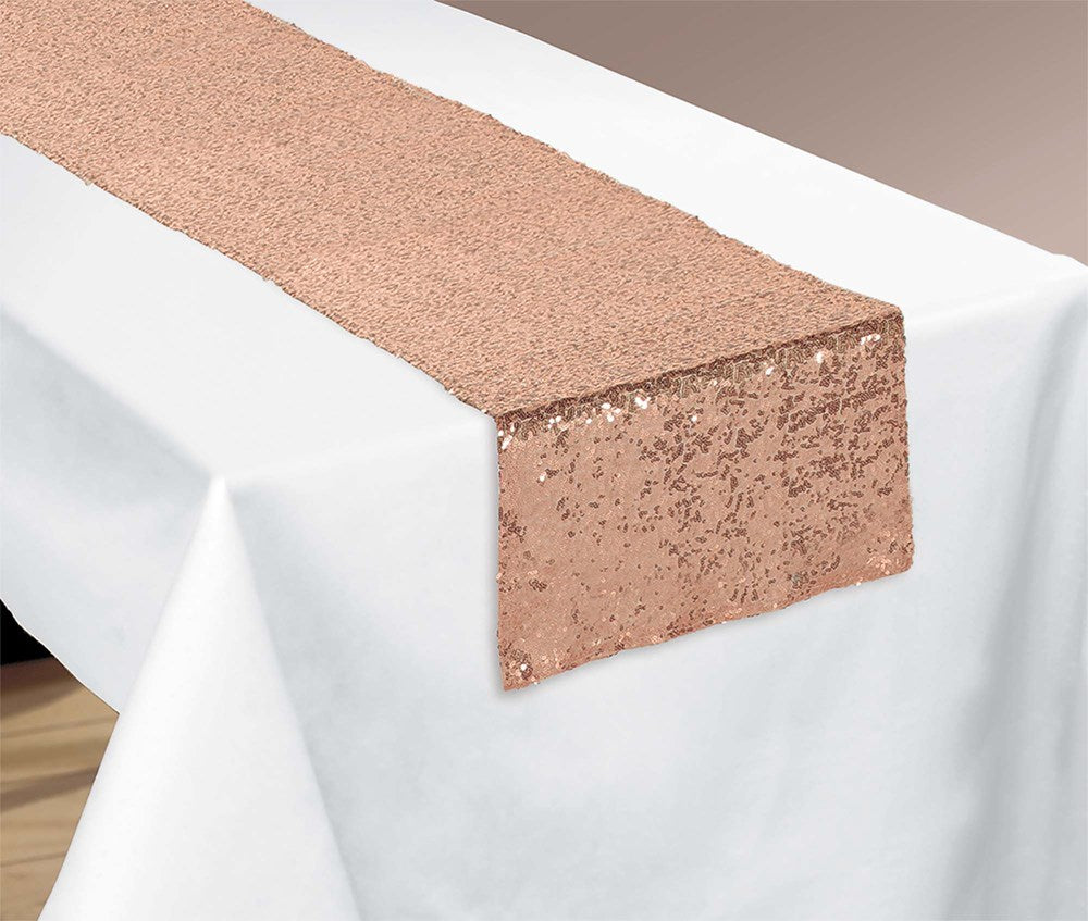 Rose gold sequin table runner 13 by 72 inches on white tablecloth.