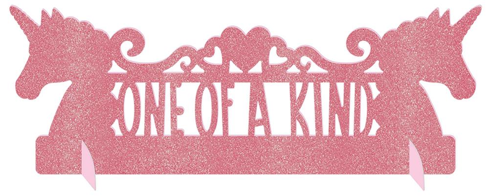 Pink glittery table decoration with two unicorn silhouettes and "One of a Kind" cut-out text.