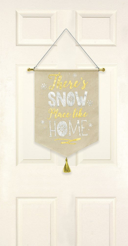 Beige fabric hanging banner with gold and white lettering, gold tassels, reading "There's Snow Place Like Home".