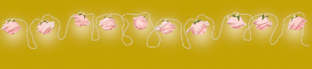Warm white LED string lights with delicate pink rose-shaped covers on thin green wires.