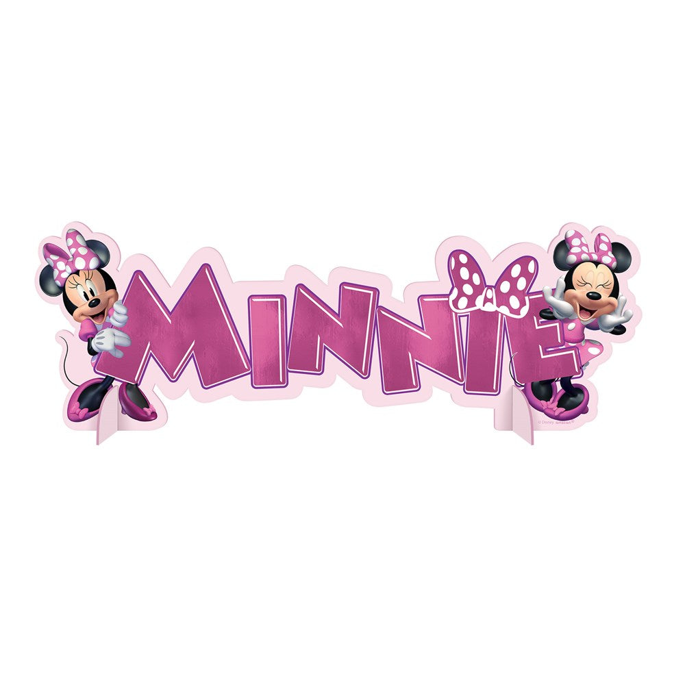 Pink and purple Minnie Mouse table decoration with bold letters and two Minnie Mouse figures wearing polka dot bows.
