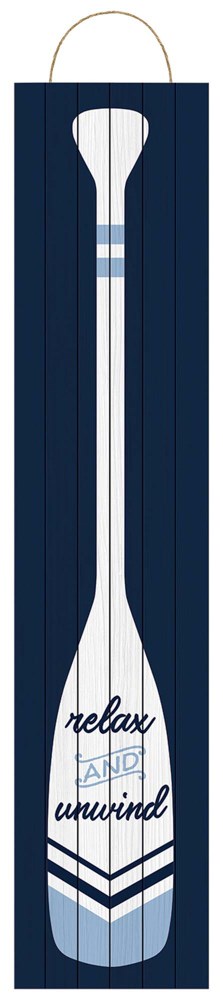 Large white wooden oar-shaped wall sign with navy blue stripes and “relax unwind” text, hanging rope.