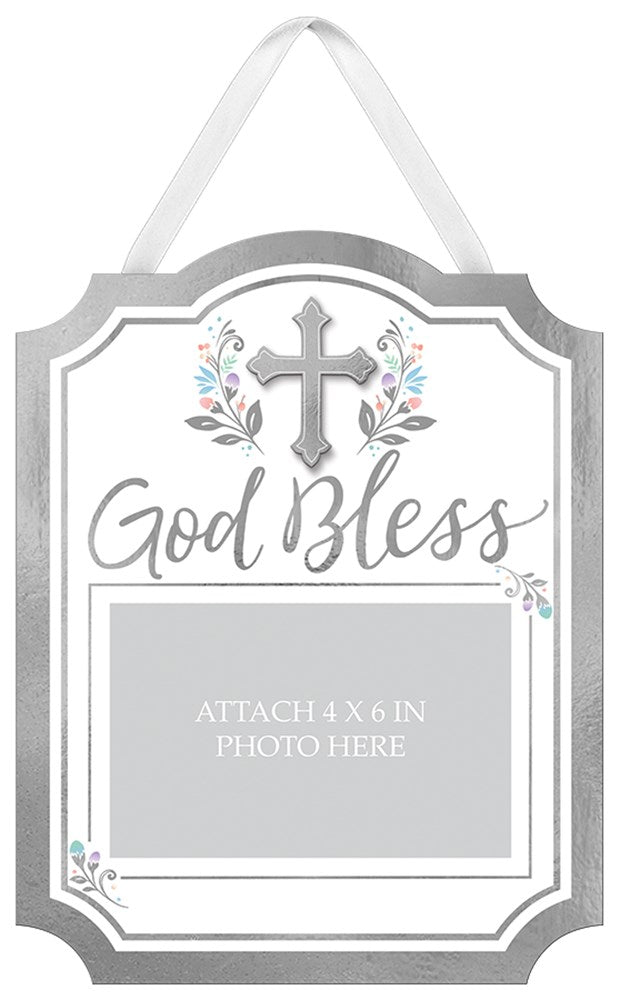 Gray and white cardboard photo sign with decorative cross, floral accents, and "God Bless" text, hanging by white ribbon.