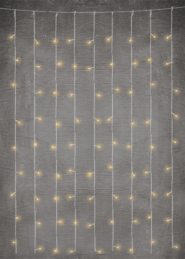 Warm white LED lights hanging in vertical cascading strands with thin silver wires against a gray background.