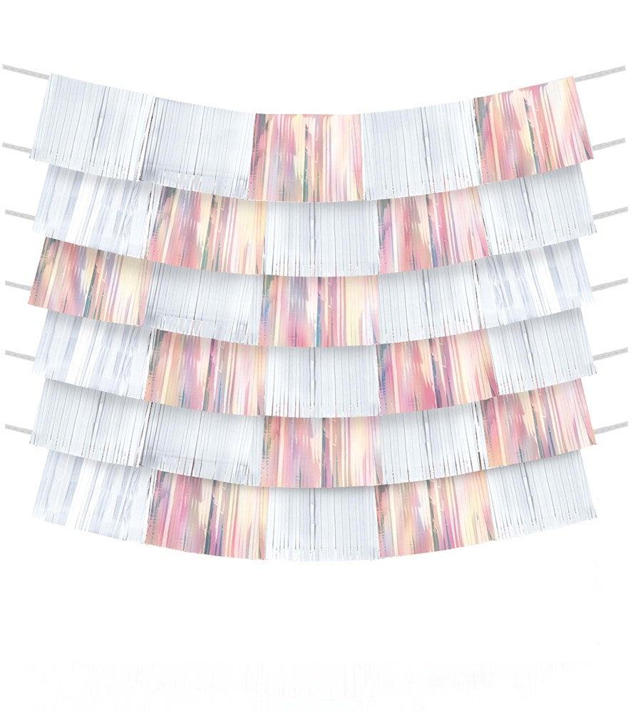 White and metallic rose gold foil fringe backdrop with layered strips hanging on string.