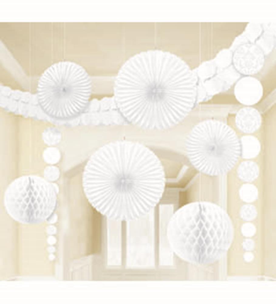 White paper fan decorations and honeycomb balls arranged for party decor.
