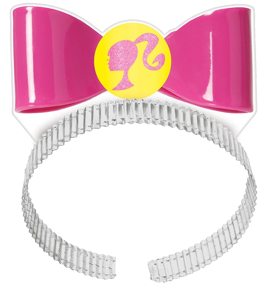 Pink plastic headband with a shiny pink bow and yellow Barbie silhouette emblem center.