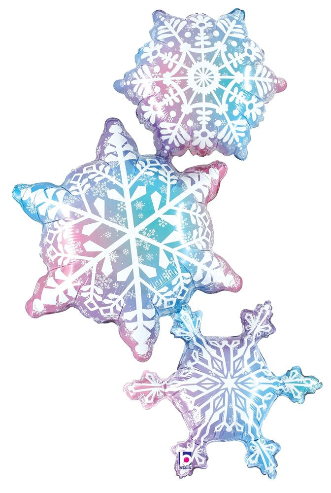 Set of three iridescent foil balloons shaped like snowflakes in varying sizes with white intricate snowflake patterns.