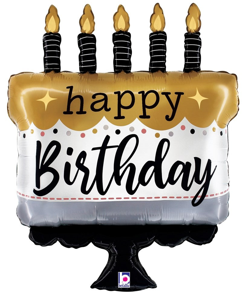 Satin metallic foil balloon shaped like a birthday cake with five black candles and gold flames, gold top layer, white.