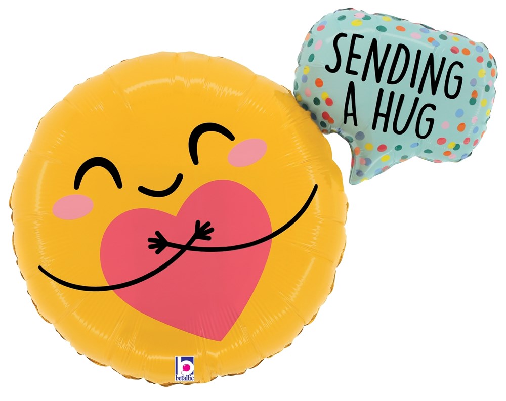 Yellow round foil balloon with a smiling face hugging a pink heart and a blue speech bubble saying "Sending a hug" with.
