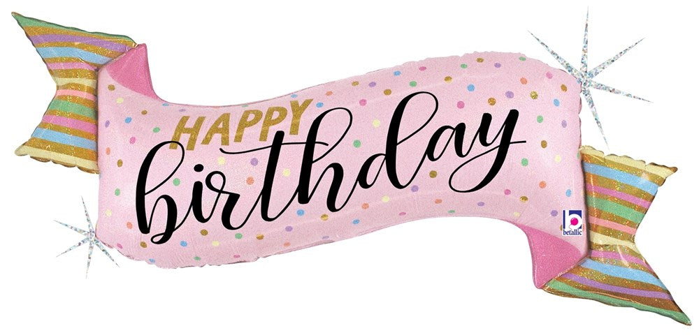 Pink holographic foil balloon shaped like a wrapped candy with "Happy Birthday" text in black script and polka dot accents.