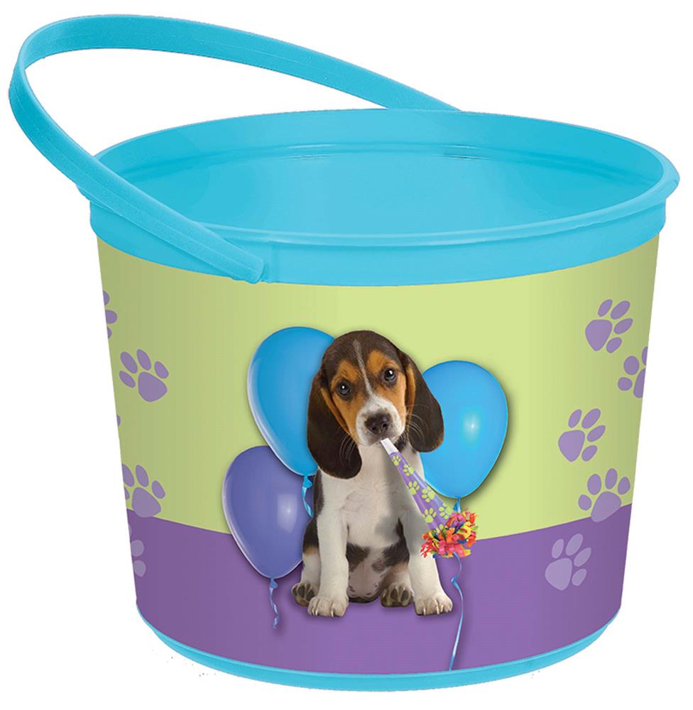 Small round plastic favor container with blue handle, decorated with a beagle puppy and blue and purple balloons on a green.