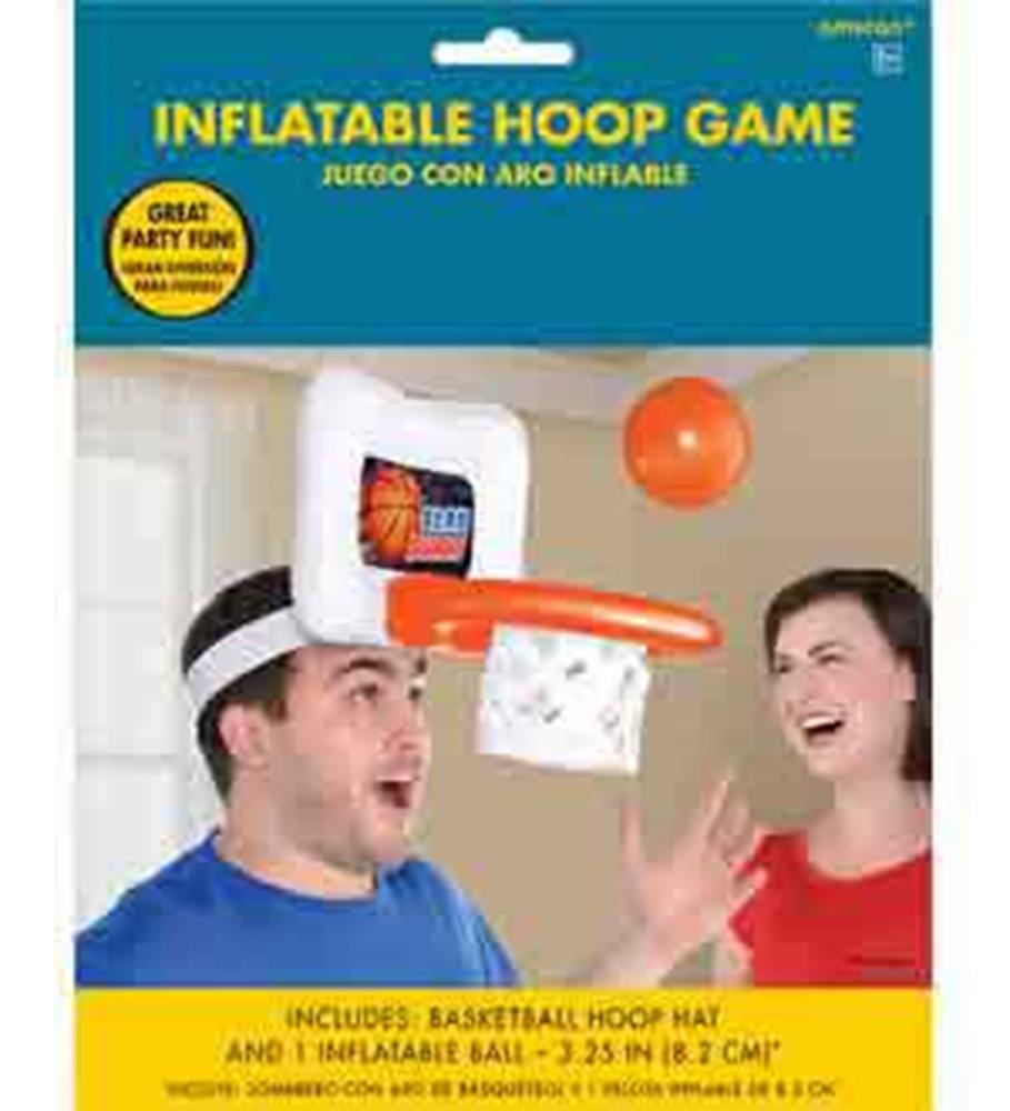 Inflatable basketball hoop game hat with orange ball and white net worn on head by man with woman smiling nearby.