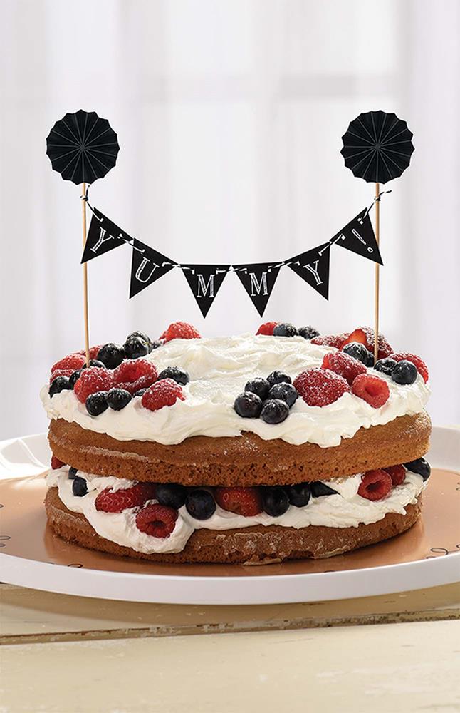 Black chalkboard table banner with white alphabet letters on triangular flags, attached to wooden sticks with black rosettes.