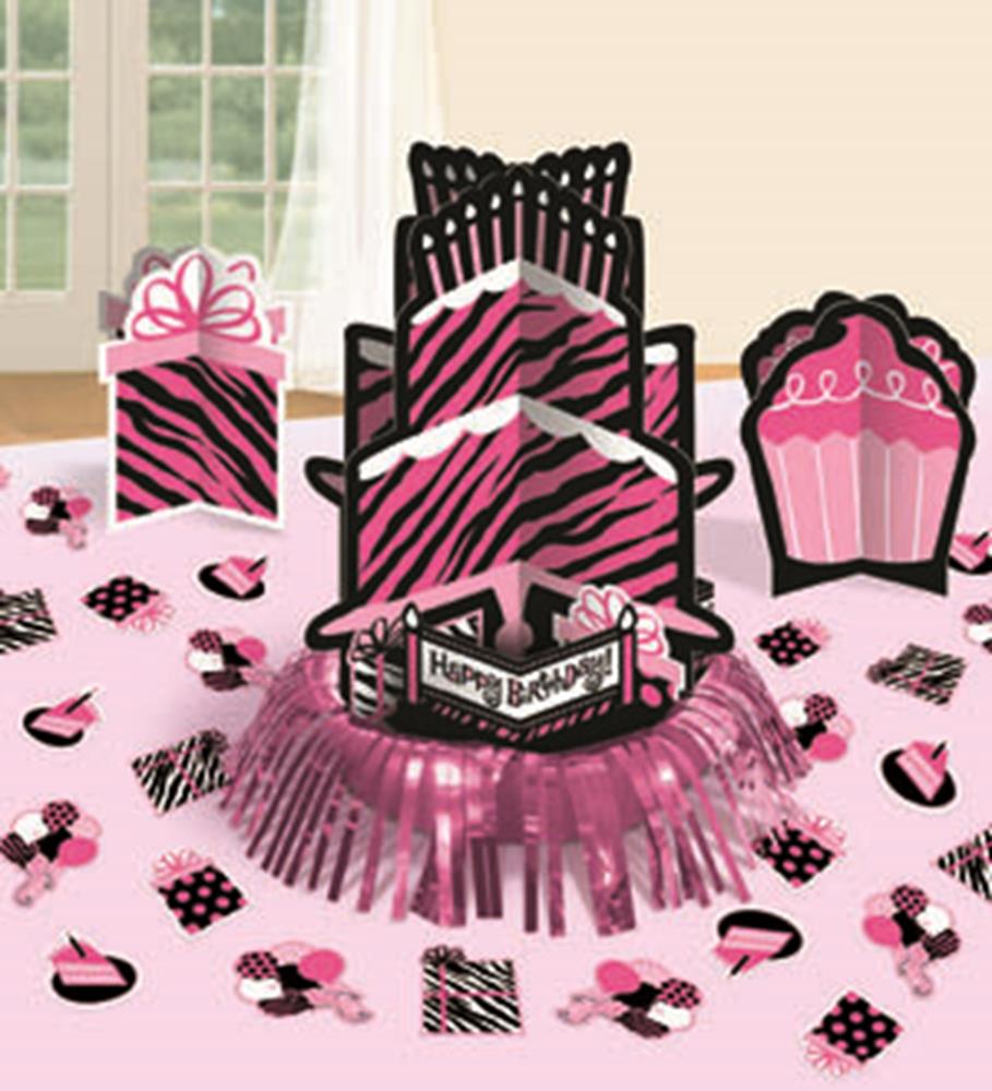 Pink and black zebra print birthday centerpiece with gift, cupcake, and confetti decorations on a pink fringe base.
