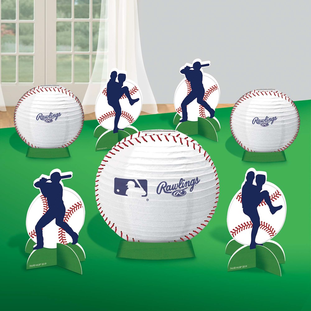 White paper lantern baseballs with red stitching and blue MLB player silhouette cutouts on green stands for party.