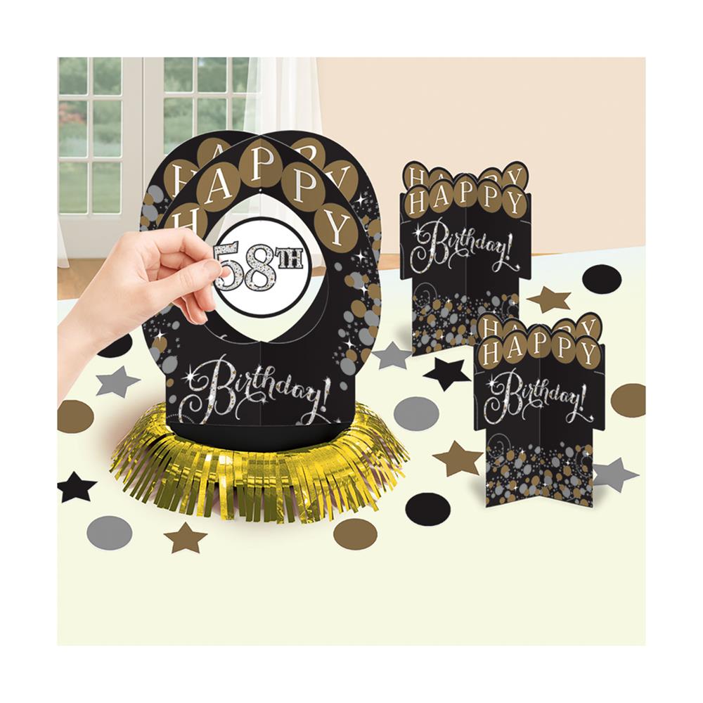Black and gold Happy Birthday table centerpiece with sparkling star accents and metallic fringe base.