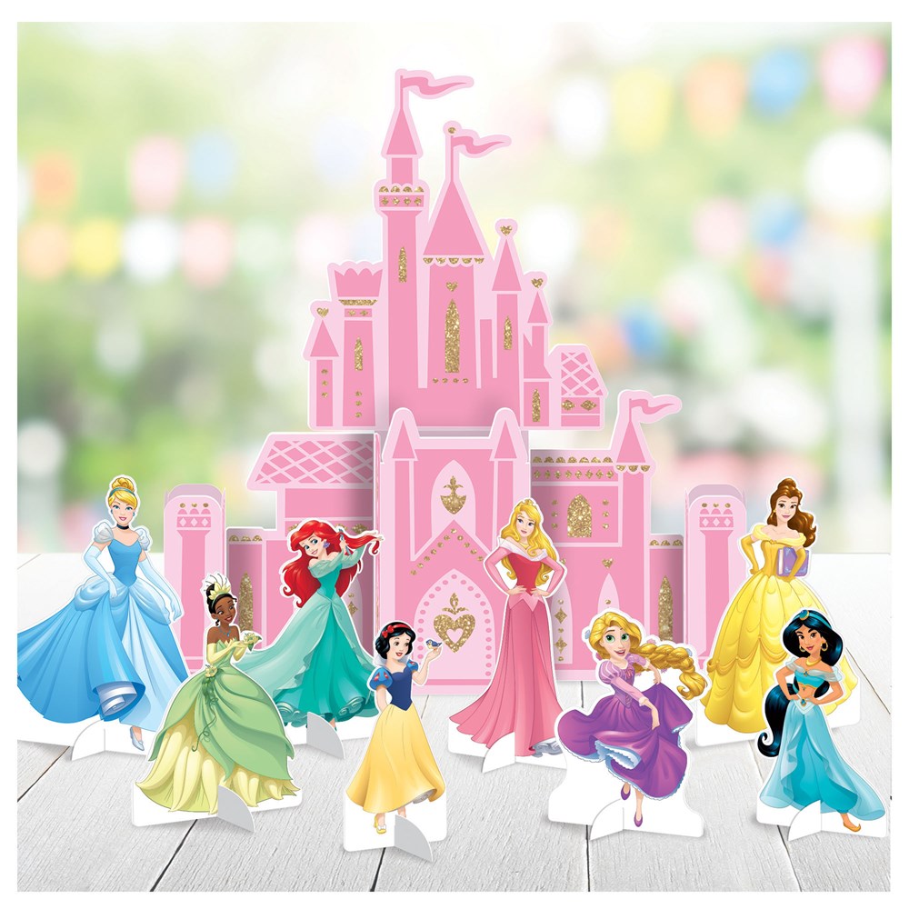 Pink castle centerpiece with seven colorful Disney princesses in front, including Cinderella and Belle.
