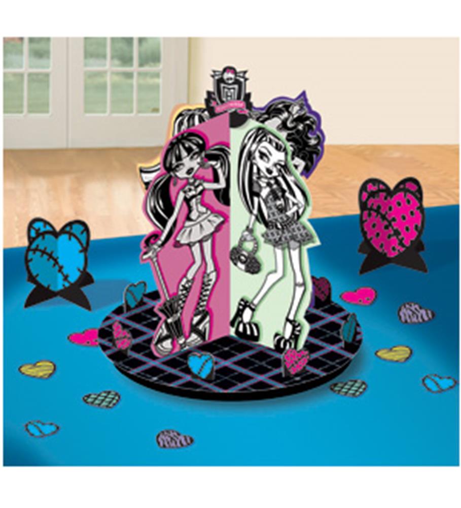Monster High table centerpiece with pink and black character cutouts on checkered base, surrounded by colorful heart.