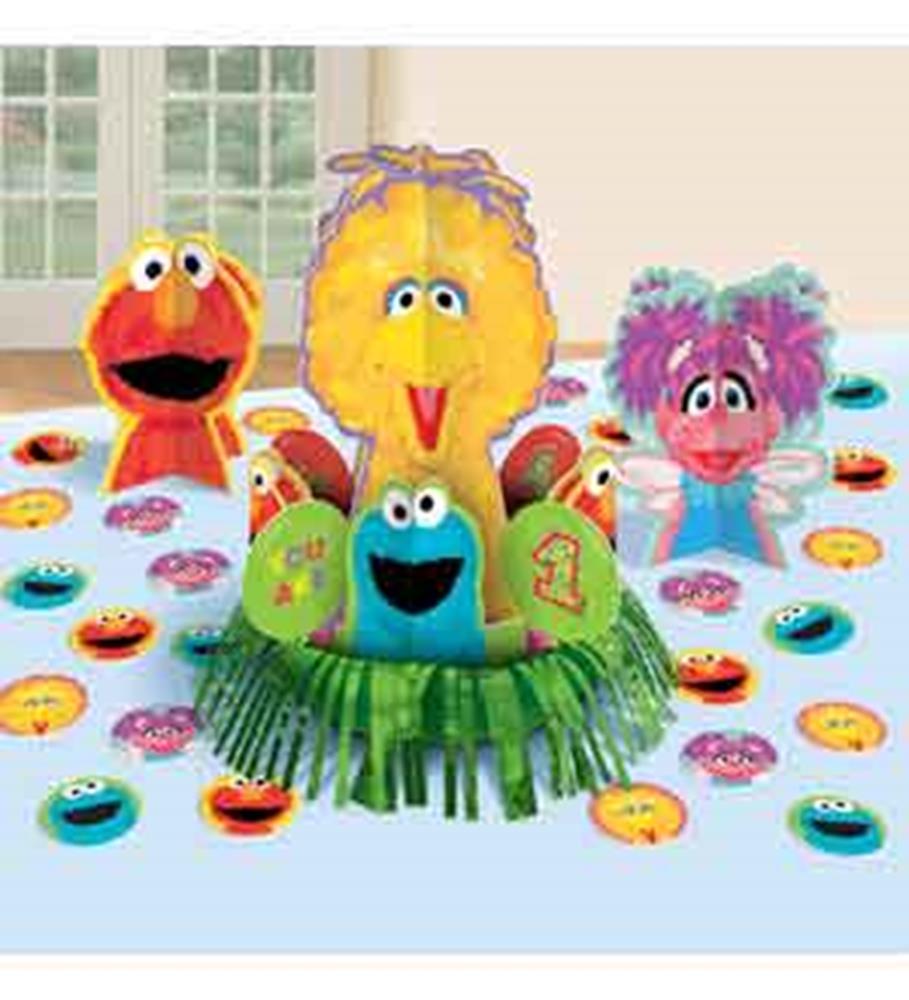 Colorful Sesame Street character centerpiece with Elmo, Big Bird, Abby Cadabby, and Cookie Monster on a blue tablecloth.