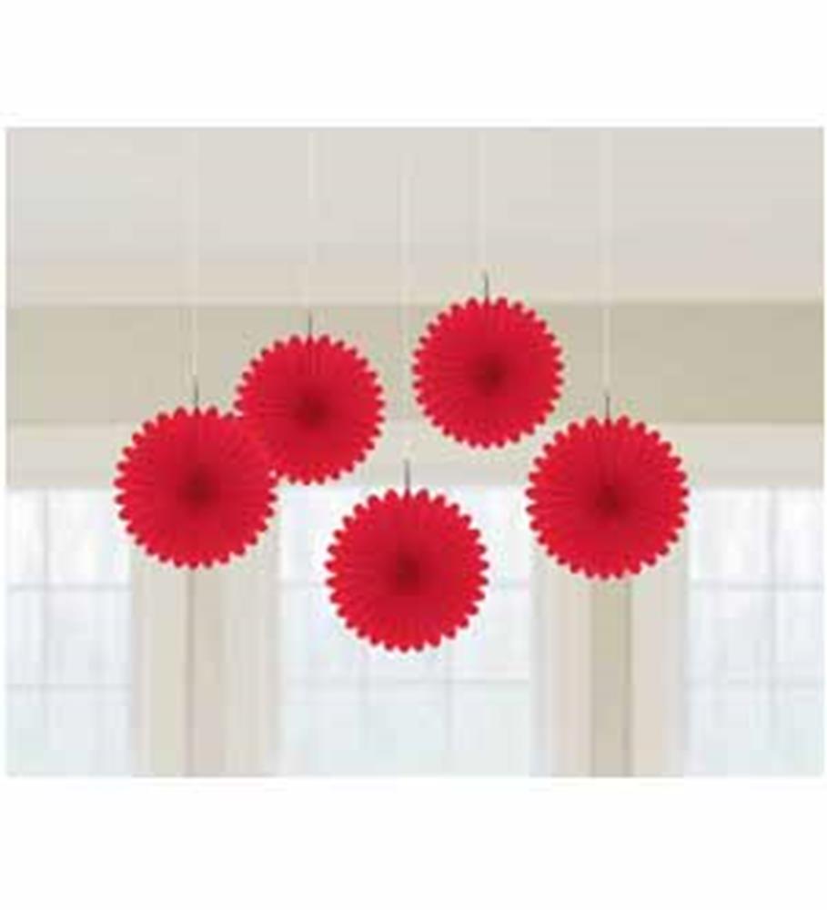 Set of five red scalloped-edge paper fans hanging by white strings against a neutral background.