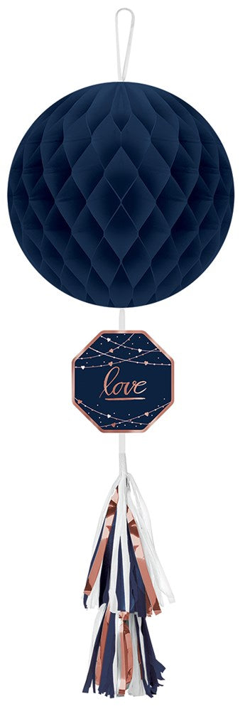 Navy blue honeycomb paper ball with diamond pattern, octagonal tag reading "love," and tassel tail in navy, white, and rose.