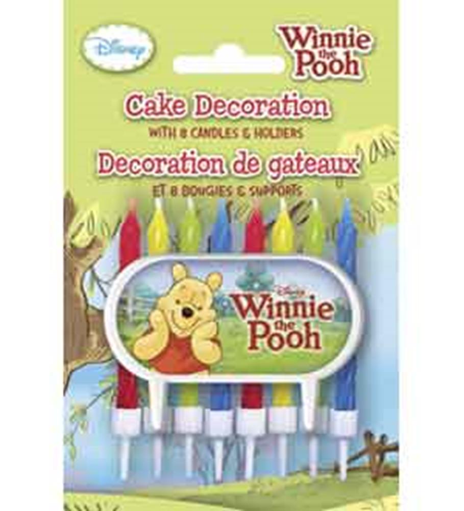 Winnie the Pooh themed cake decoration with 8 colorful candles and character illustration.