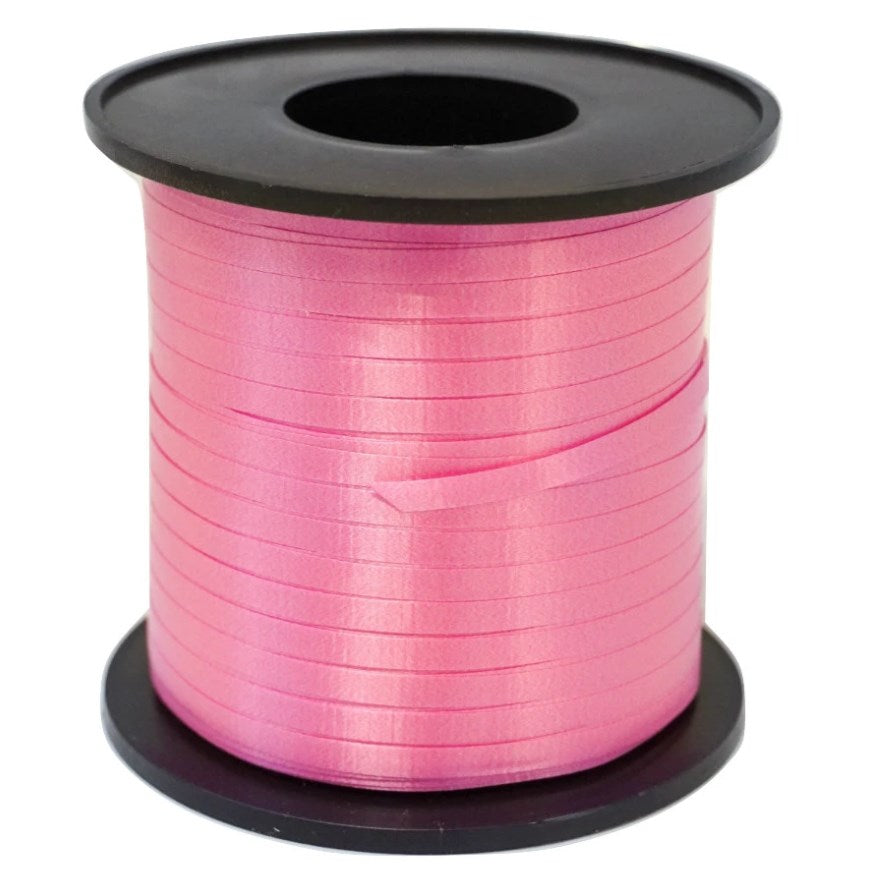 Spool of shiny fuchsia curling ribbon with thin, smooth plastic strands wound tightly on black plastic core.