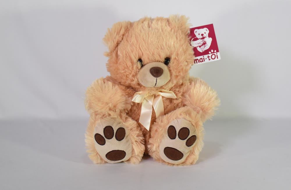 Light brown plush teddy bear with dark brown paw pads and a cream-colored ribbon around its neck.