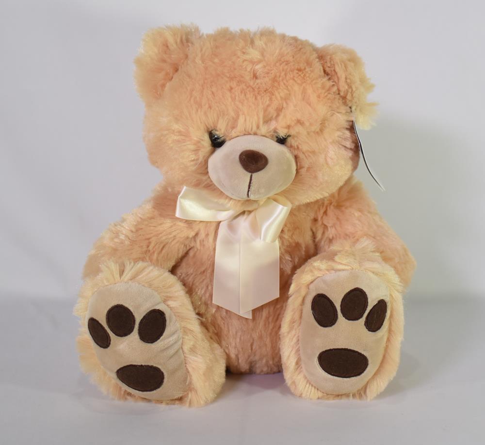 Light brown plush teddy bear with dark brown paw pads and a cream satin bow around its neck, sitting upright.