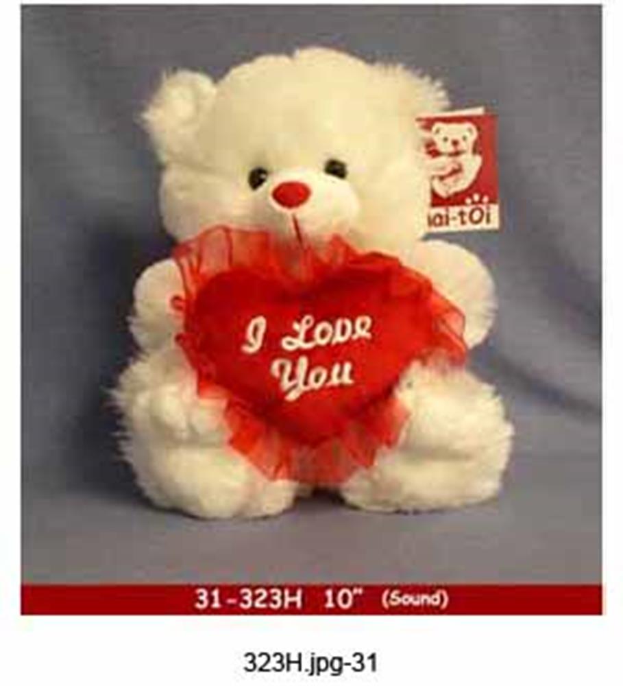 White plush teddy bear holding a red heart-shaped pillow with "I Love You" embroidered in white.
