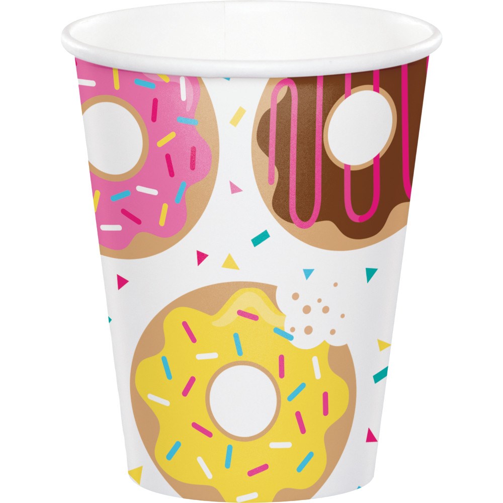 White paper cup with colorful sprinkled donuts in pink, chocolate, and yellow icing designs.
