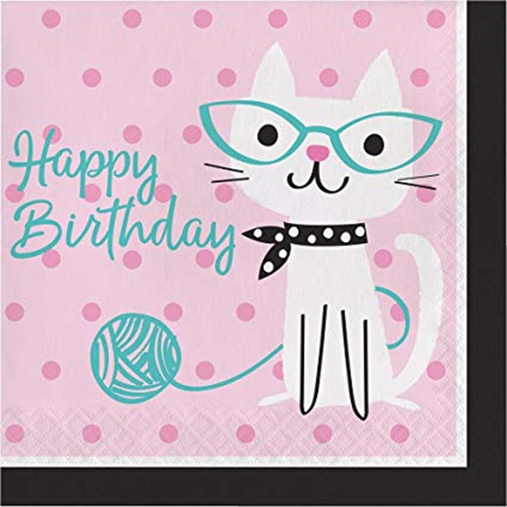 Pink square napkin with polka dots, white cat wearing teal glasses and black scarf, teal yarn ball, and "Happy Birthday".