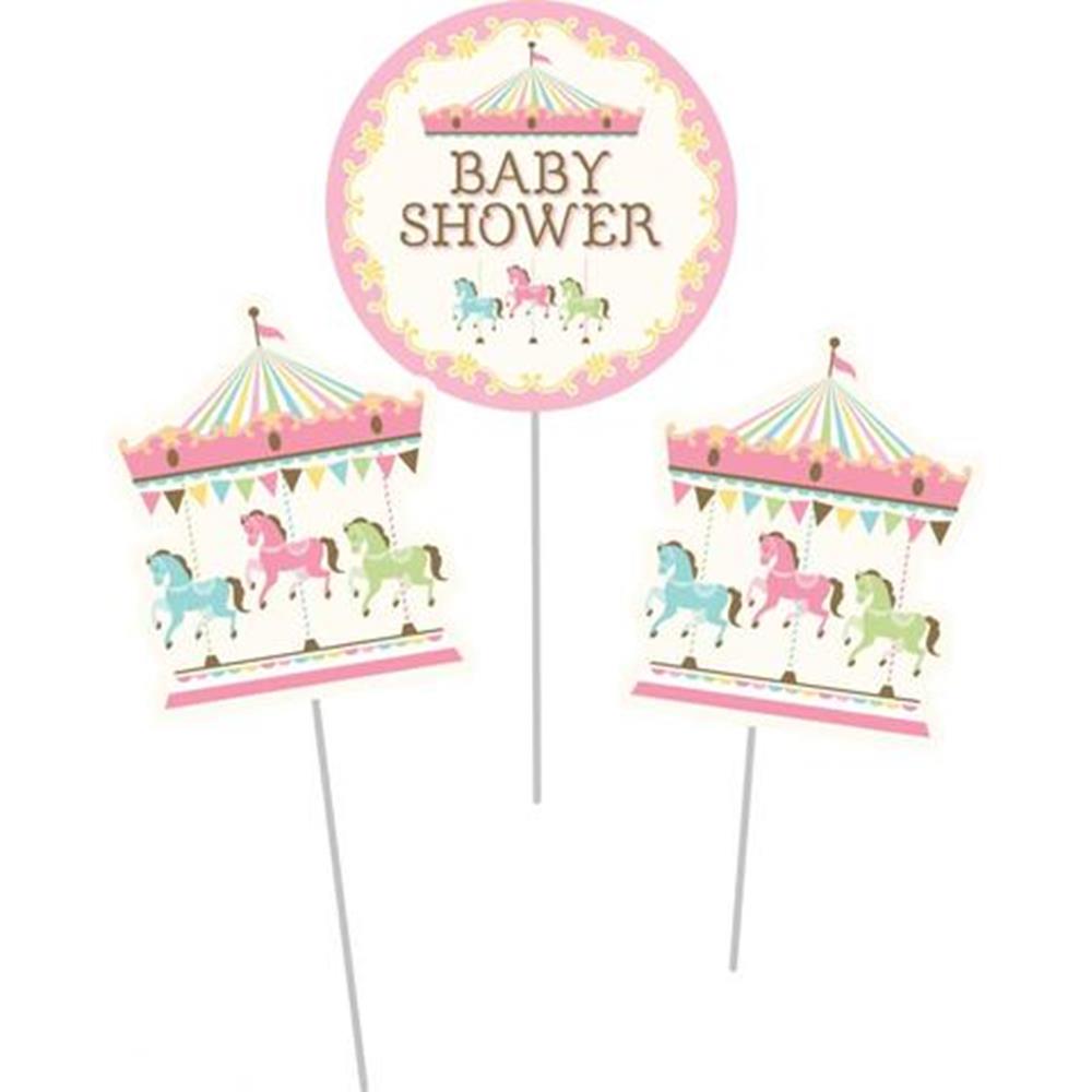 Three carousel-themed centerpiece sticks with pastel pink, green, and blue horses, two featuring carousel tents and one.