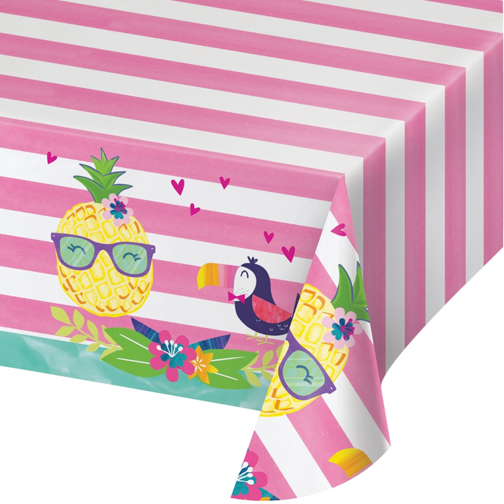 Pink and white striped tablecover with cartoon pineapples wearing sunglasses and colorful toucans on a green and blue border.