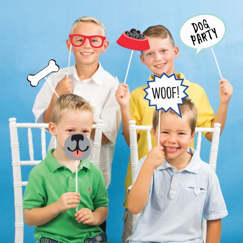 Set of 10 colorful dog party photo props including bone, dog bowl, speech bubbles, dog nose, and red glasses on sticks.