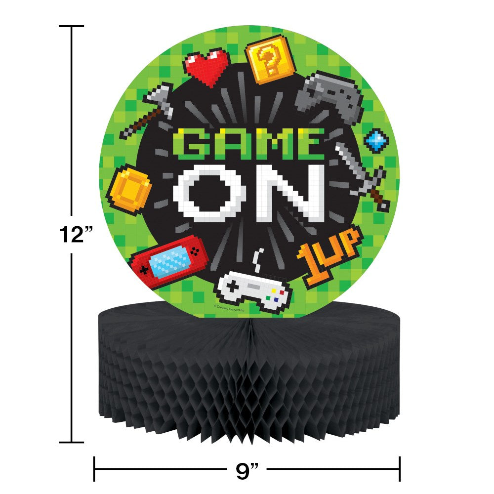 Round gaming party centerpiece with pixel art icons and "GAME ON" text on a black honeycomb base.