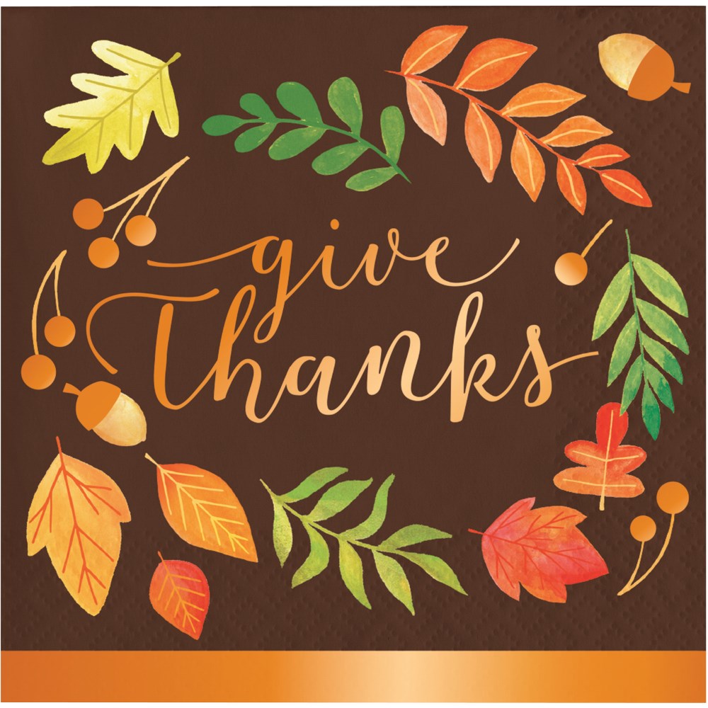Brown beverage napkin with orange, green, and yellow autumn leaves and acorns surrounding "Give Thanks" in orange script.