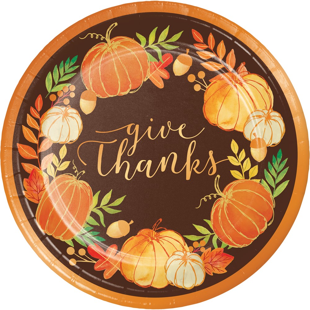 Round foil plate with orange border featuring autumn pumpkins, leaves, acorns, and gold script "give thanks" on dark brown.