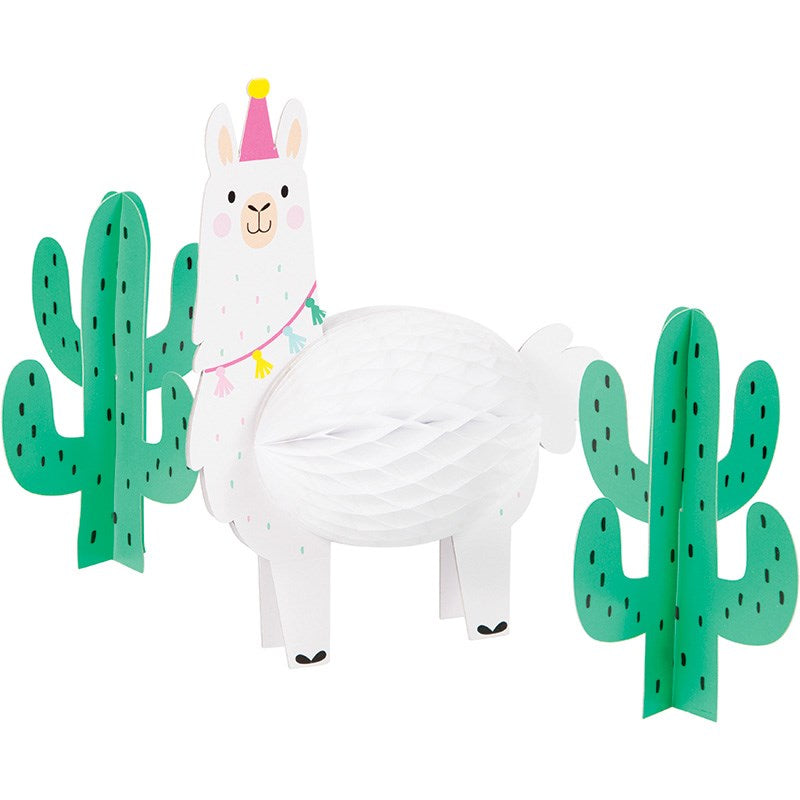 White honeycomb paper llama centerpiece with pink party hat and colorful garland, flanked by two green cactus decorations.