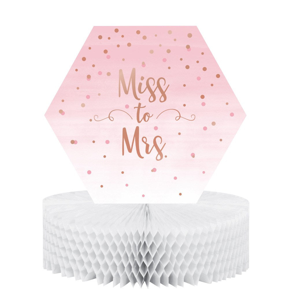 Hexagonal pink ombre party sign with rose gold confetti and "Miss to Mrs." text on white honeycomb base.