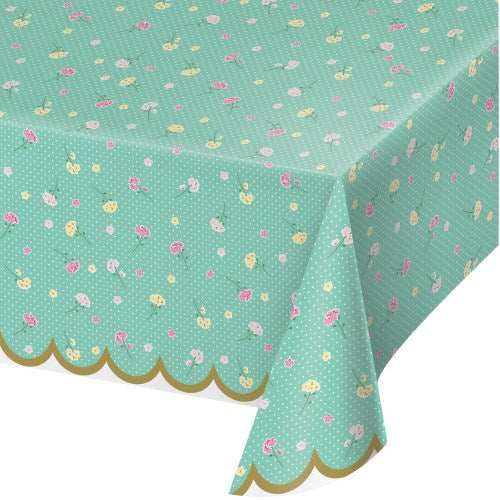 Teal rectangular plastic tablecover with small pink and white floral patterns and scalloped gold-edged border.
