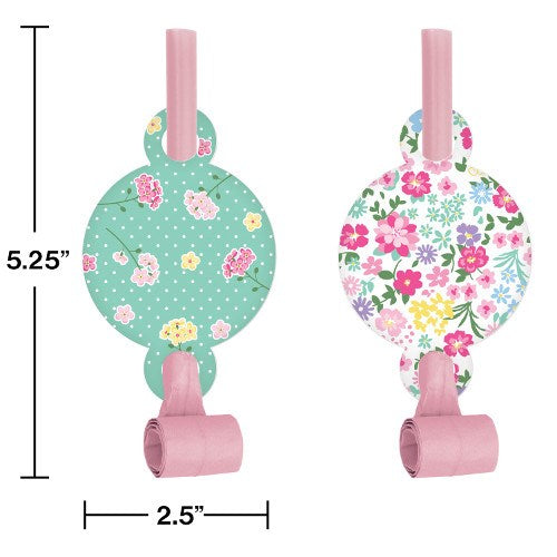 Two pink party blowouts with round floral paper covers; one green with white and yellow flowers, one white with colorful.