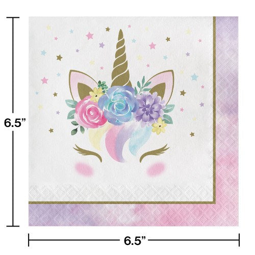White square napkin with a gold unicorn horn, pastel floral crown, closed eyes, and rainbow mane, bordered in pink and gold.
