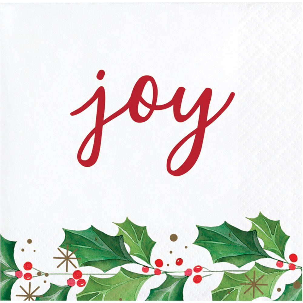 White beverage napkin with red "joy" text and green holly leaves with red berries design at the bottom.