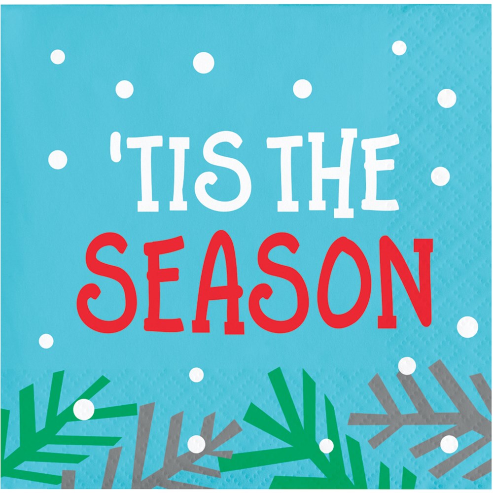 Blue square beverage napkin with white dots, green pine branches, and red and white "'Tis the Season" text.