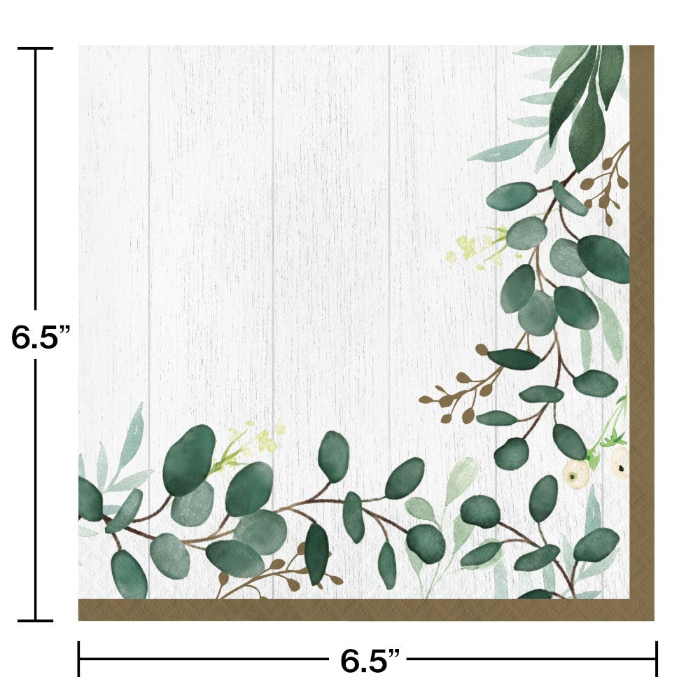 Square white paper napkin with green eucalyptus leaves and small brown branches along two edges.