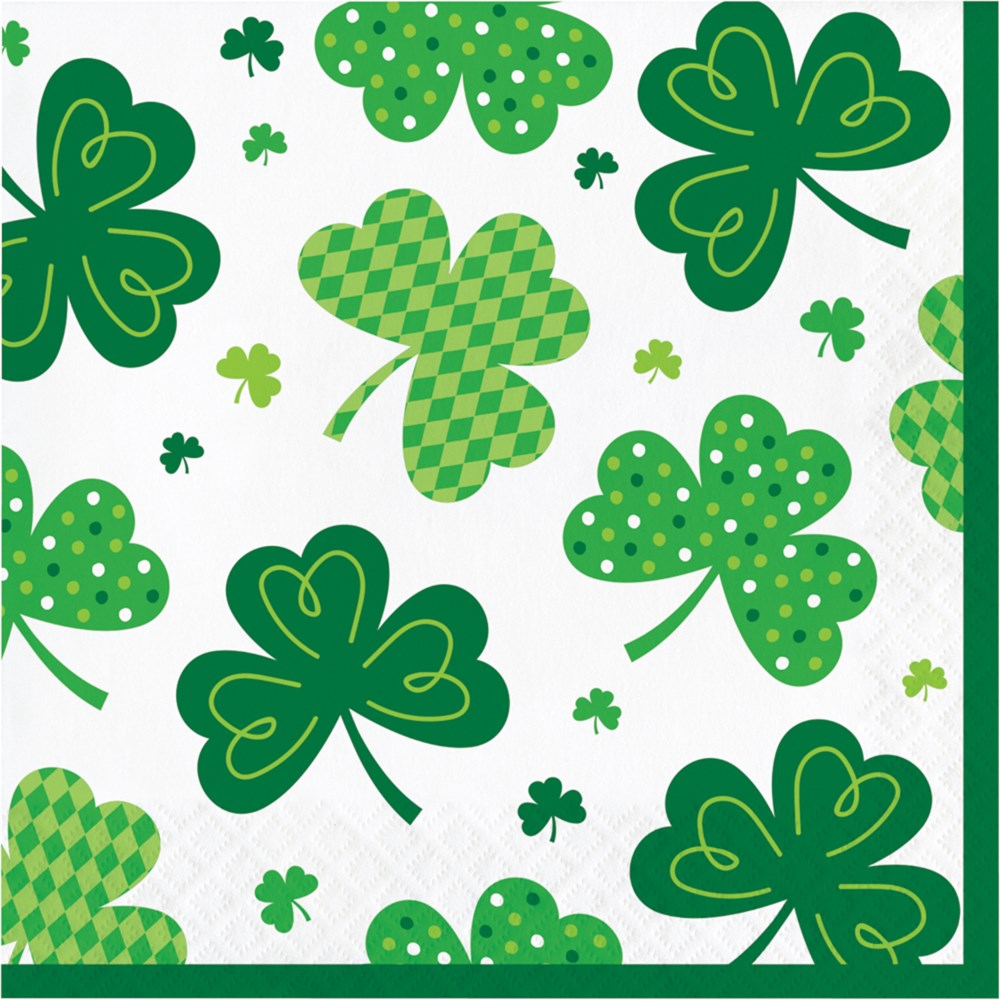 White luncheon napkin with various green shamrocks in solid, polka dot, and checkered patterns.