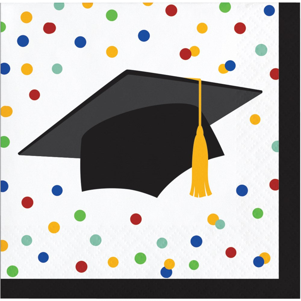 Square beverage napkin with black graduation cap and gold tassel on white background with multicolored confetti spots.